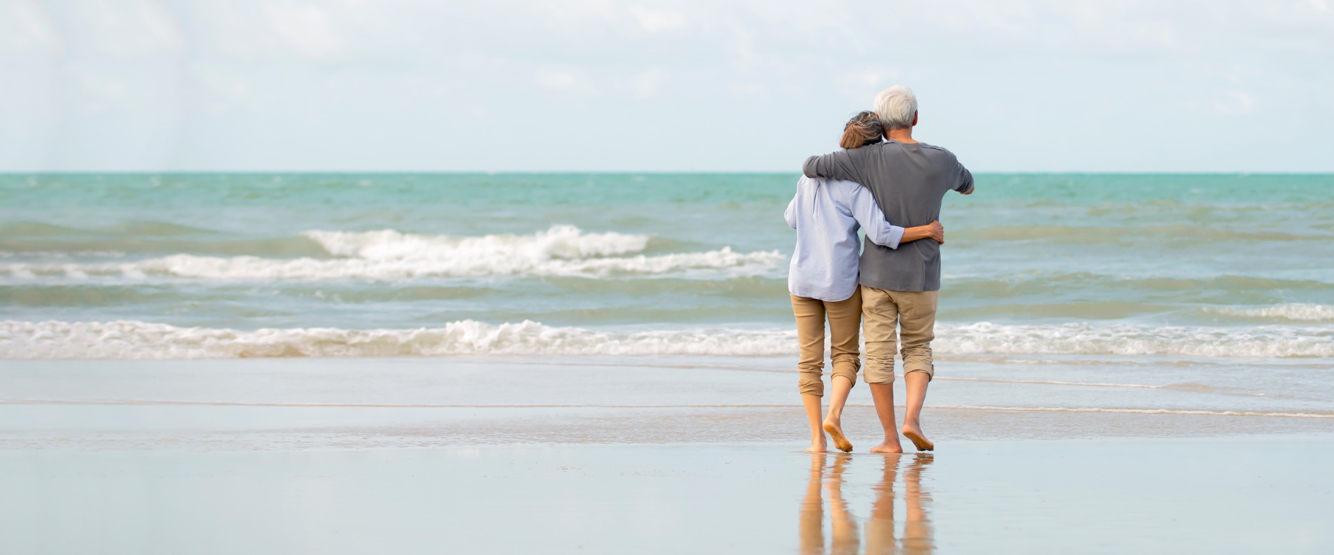 Couple walking on a beach.