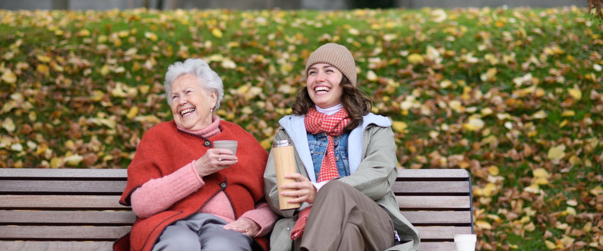 Mother and daughter on a park bench.